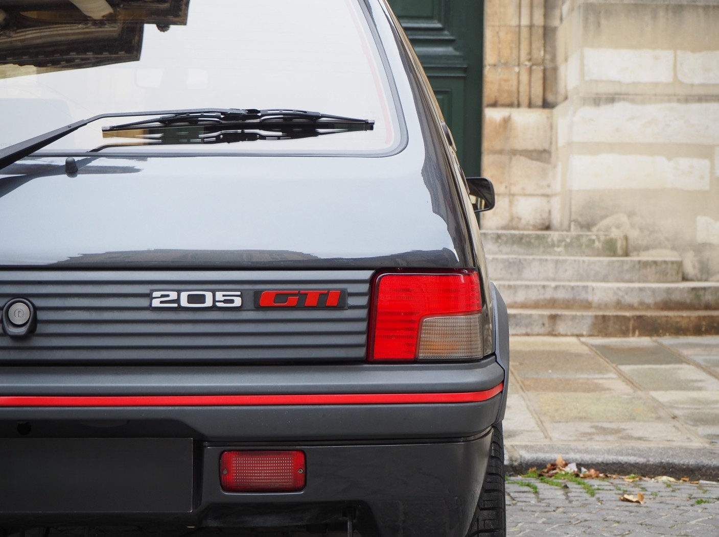 Peugeot 205 GTI front detail in a workshop setting